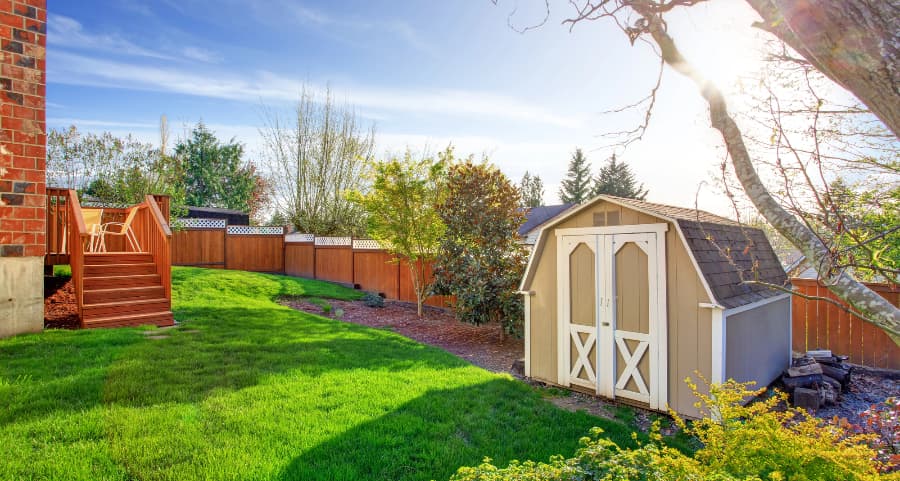 Fenced backyard with storage shed in Evansville